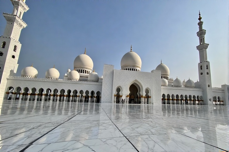 Sheikh Zayed Grand Mosque with domes and white marble reflecting the sky